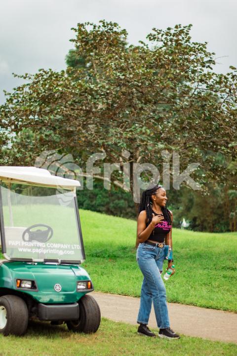 Girl in front of a Golf cart