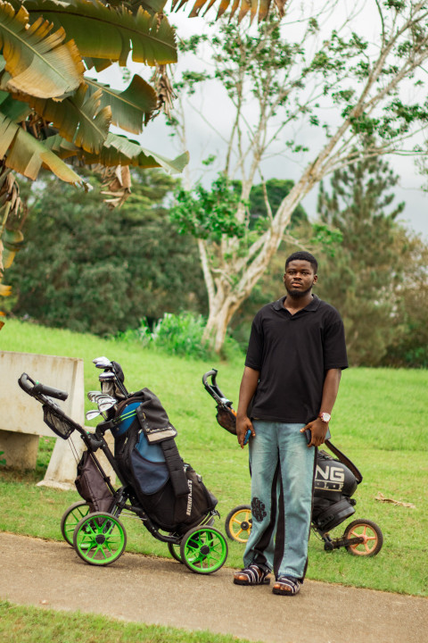 Boy in front cart golf bag