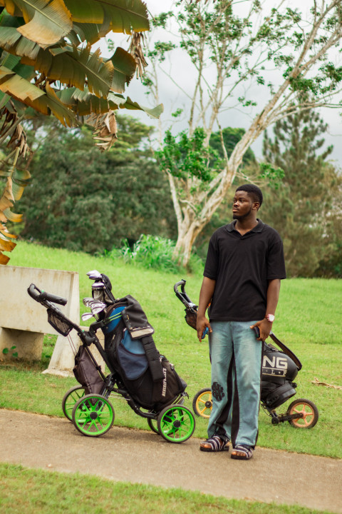 Boy in front of cart golf bag 1