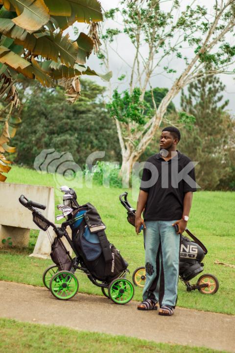 Boy in front of cart golf bag 1