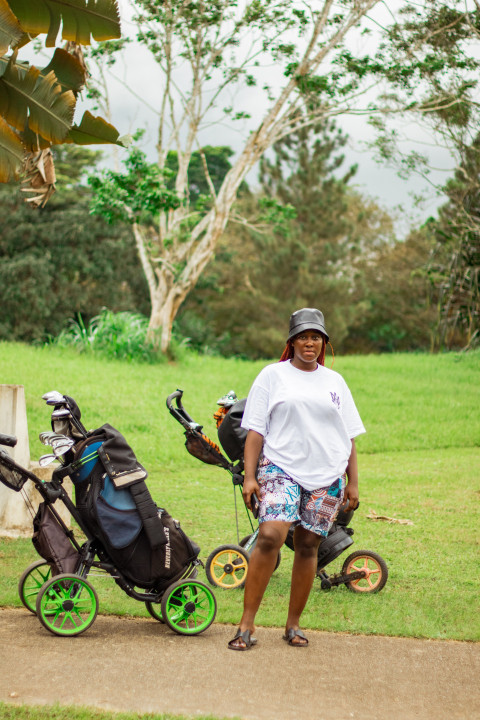 Girl in front of cart golf bag