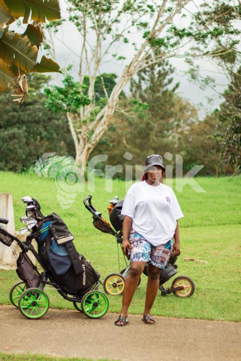 Girl in front of cart golf bag