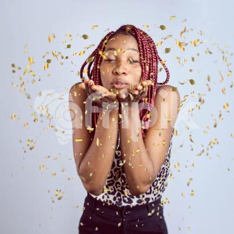 Girl blowing confetti