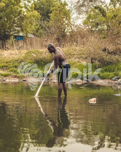 A fisherman and his net in a river